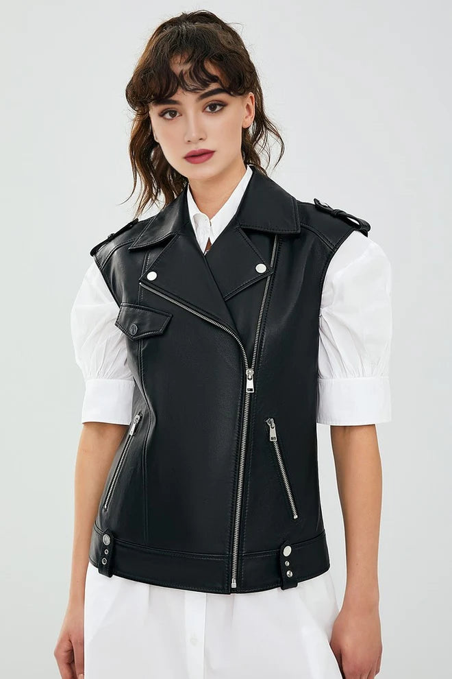 Woman wearing a black leather vest over a white shirt on a light gray background
