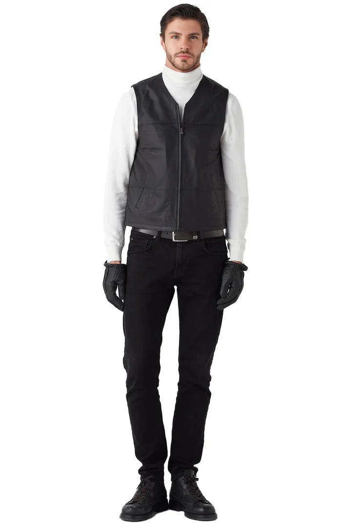 Man wearing a black vest over a white shirt on a white background