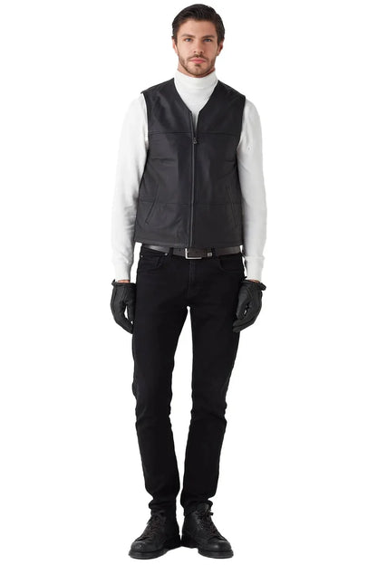 Man wearing a black vest over a white shirt on a white background