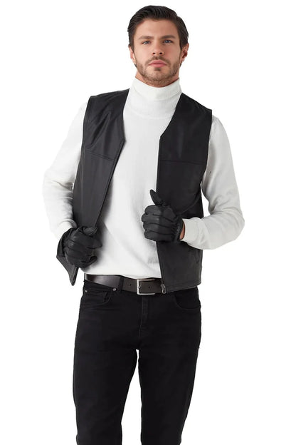 Man wearing a black vest over a white shirt with black gloves and pants on a white background