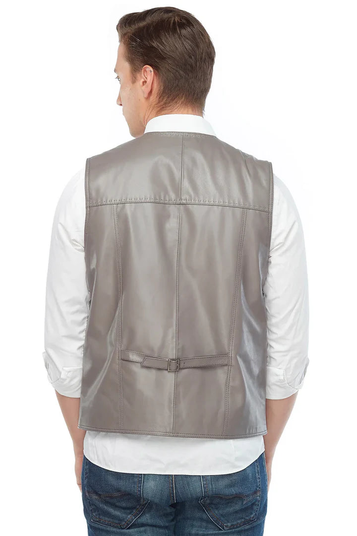Man wearing a gray leather vest over a white shirt on a white background