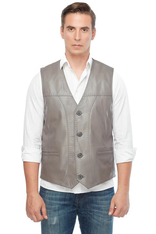 Man wearing a gray vest over a white shirt on a white background