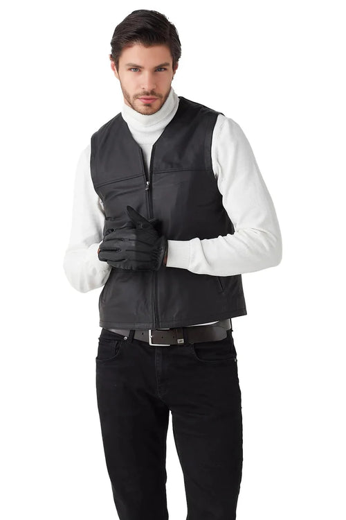 Man wearing a black vest over a white shirt on a white background