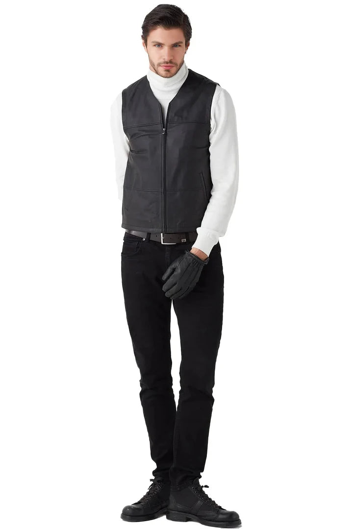Man wearing a black vest over a white shirt on a white background