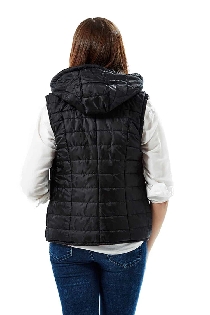 Person wearing a black quilted vest on a white background