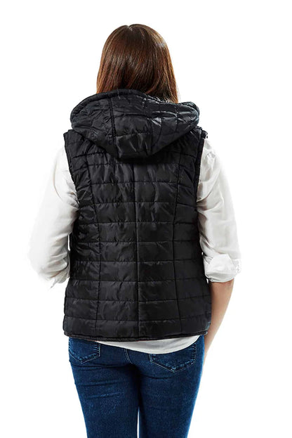 Person wearing a black quilted vest on a white background