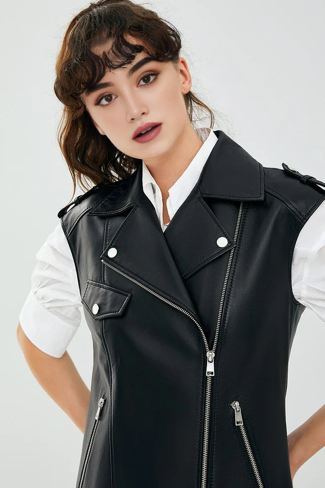 Woman wearing a black leather vest over a white shirt on a light gray background