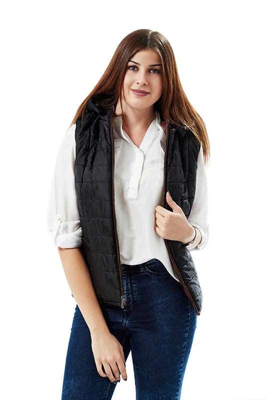 Woman wearing a black quilted vest over a white shirt and blue jeans on a white background