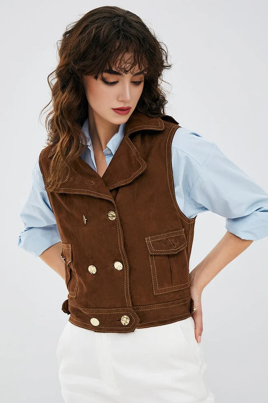 Woman wearing a brown vest over a light blue shirt on a white background